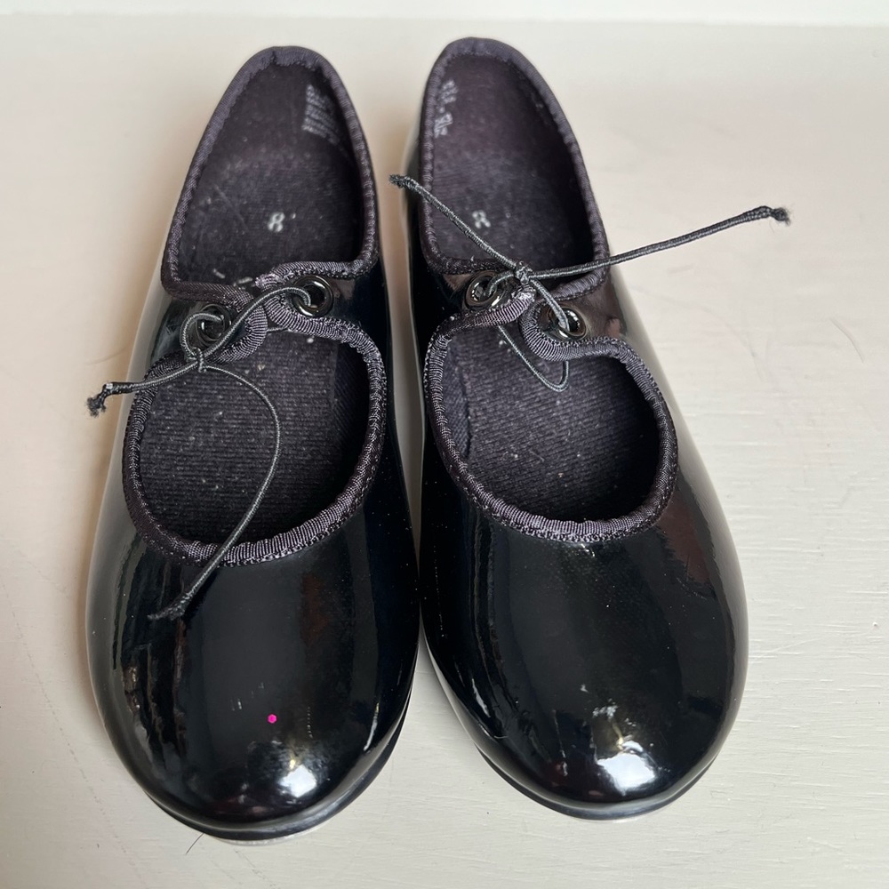 Children’s black American ballet theater, spotlights tap shoes.